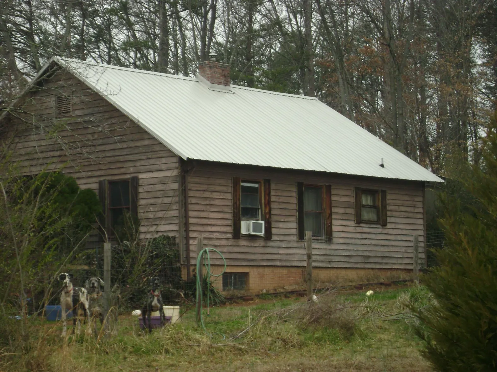 White metal roof on an old wood sided farmhouse, from a Metal Roof Installation job in Sunbury